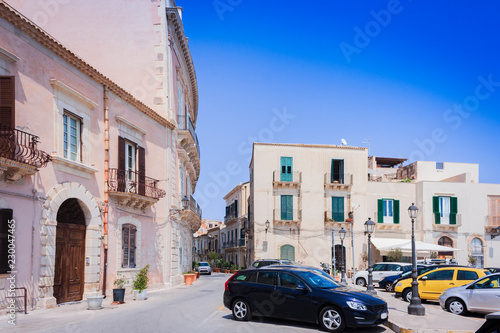 View of old street, facades of ancient buildings in Ortygia (Ortigia) Island, Syracuse, Sicily, Italy, traditional architecture © Inna