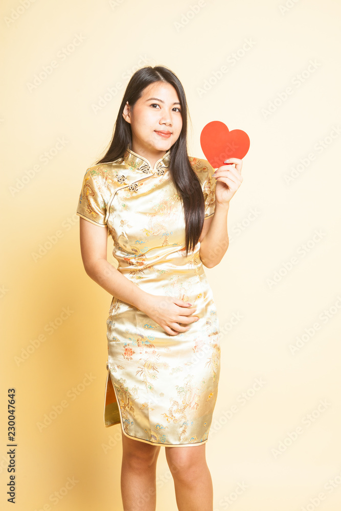 Asian girl in golden chinese cheongsam dress Asian girl in golden chinese cheongsam dress