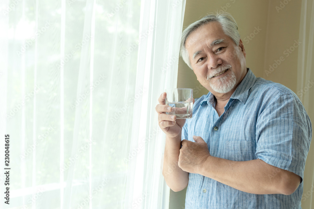 Senior man feel happy drinking fresh water in the morning, enjoying time in his home indoor background - lifestyle senior happiness concept Senior man feel happy drinking fresh water in the morning, enjoying time in his home indoor background - lifestyle senior happiness concept
