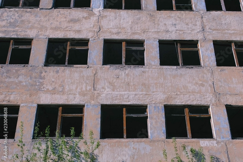 Destroyed multi-storey building with many broken windows.