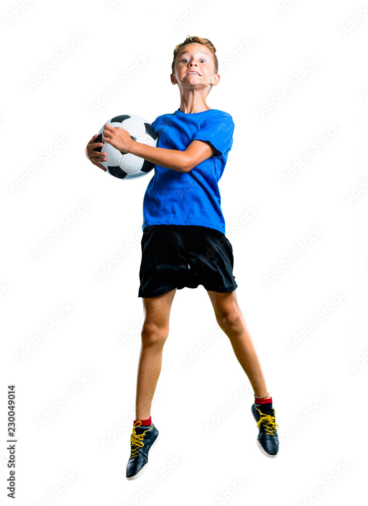 A full-length shot of Boy playing soccer and jumping on isolated white background