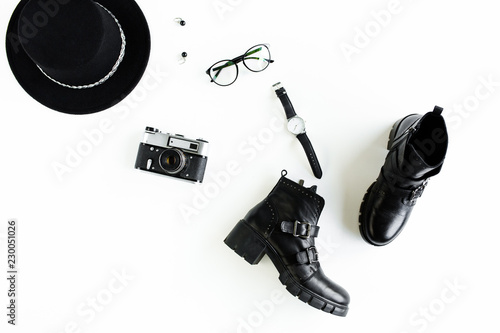 Women fashion accessories on white background top view. Flat lay female style look with Black hat and bots. Top view.