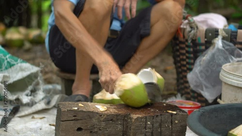 Thai Man Hacking Fresh Coconut With Machete