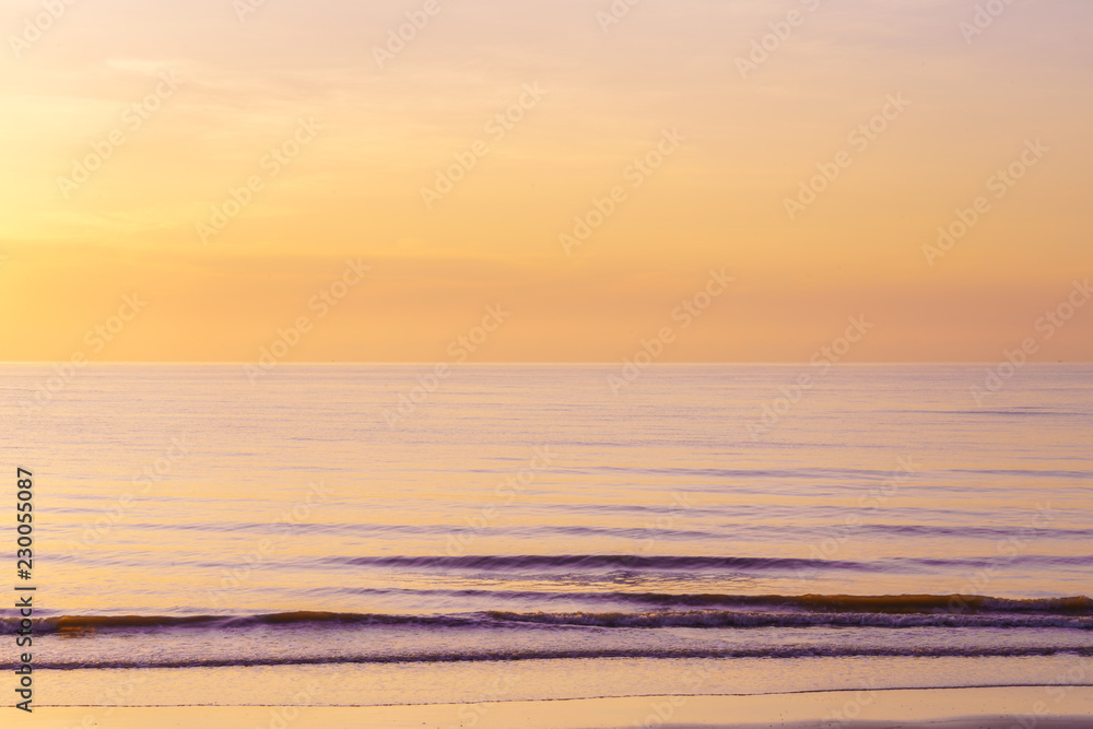 Landscape of paradise tropical beach, beautiful sunrise twilight time, pastel orange color sky and sea background.