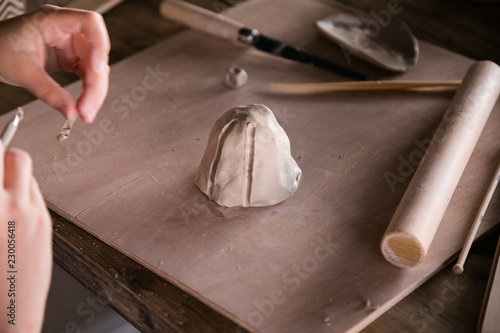 Kid sculpts from clay. Hands close-up photo