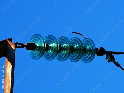 Εκτύπωση καμβά Glass insulators on a power line against a clear blue sky