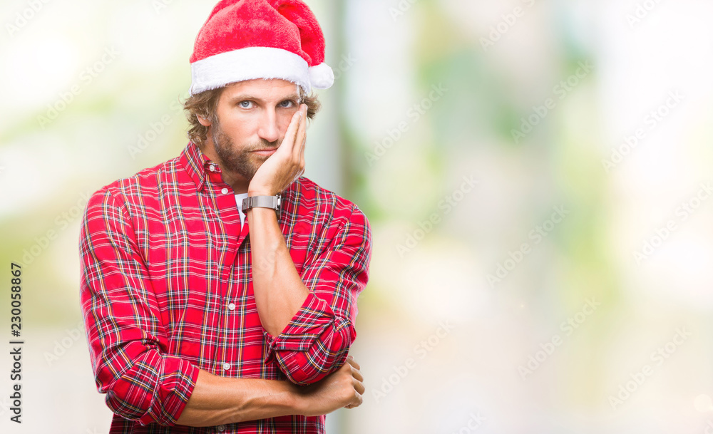 Handsome hispanic man model wearing santa claus christmas over isolated background thinking looking tired and bored with depression problems with crossed arms.