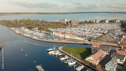 Recreational port with boats and boat houses with in the background Het Gooi lake in The Netherlands