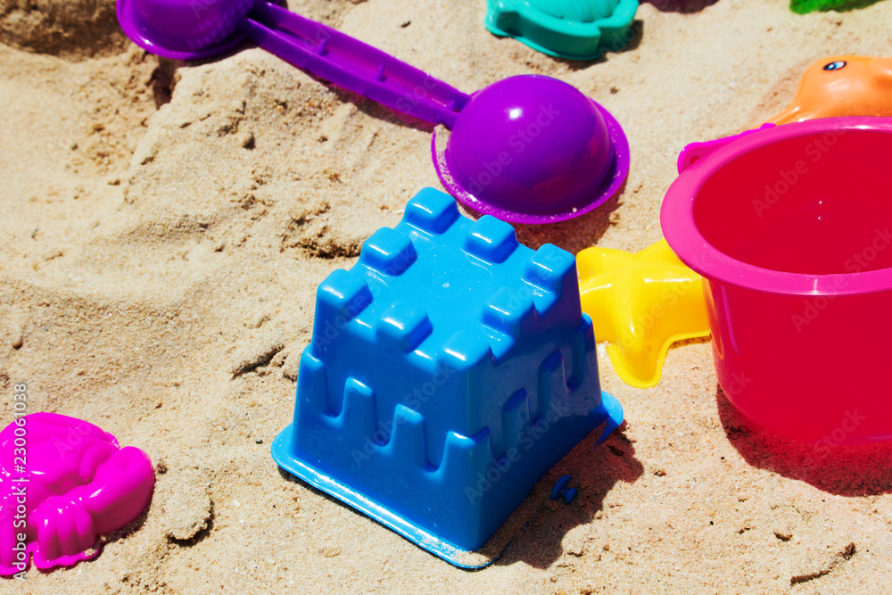 colorful toy kids with sand background colorful toy kids with sand background