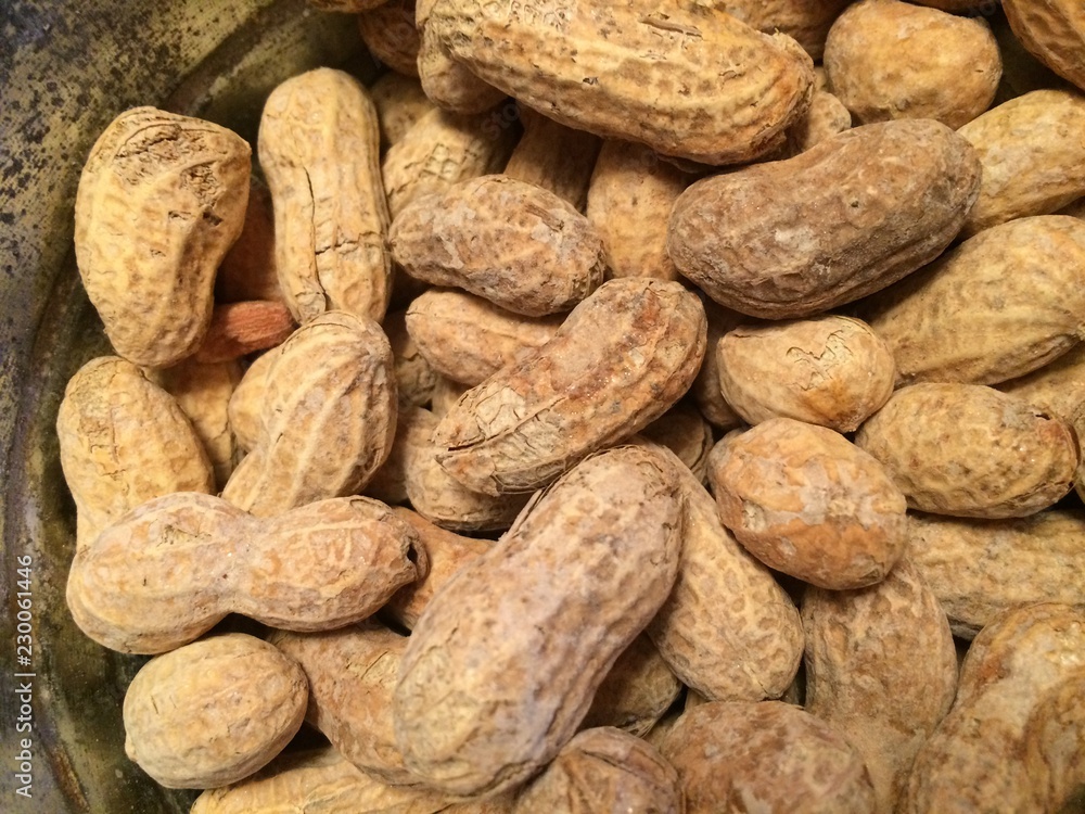 Background made of roasted peanuts in a pile Background made of roasted peanuts in a pile