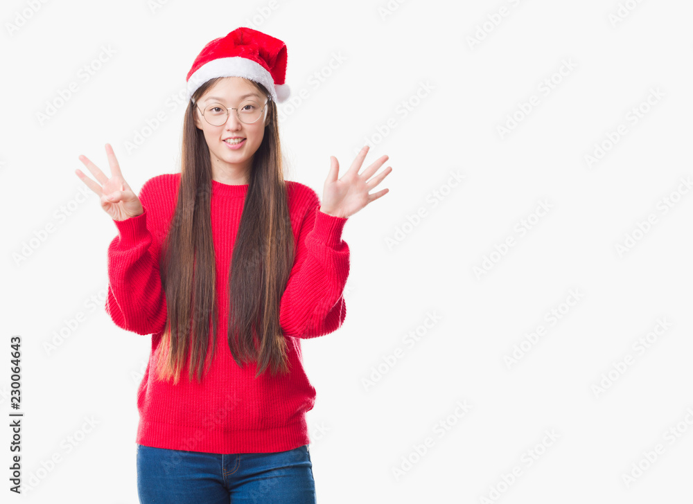 Young Chinese woman over isolated background wearing christmas hat showing and pointing up with fingers number eight while smiling confident and happy. Young Chinese woman over isolated background wearing christmas hat showing and pointing up with fingers number eight while smiling confident and happy.