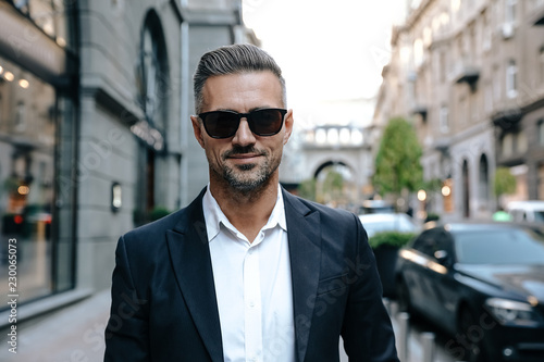 City walk. Man portrait. Handsome man is looking at camera and smiling; outdoors