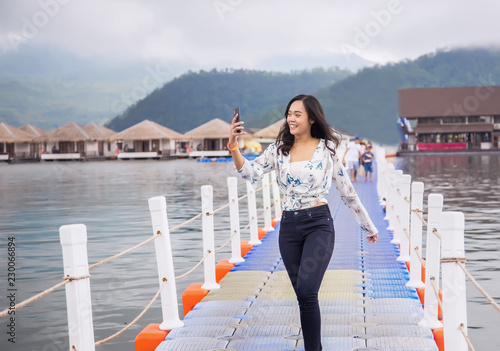 asian girl selfie by mibile phone outdoor travel. photo