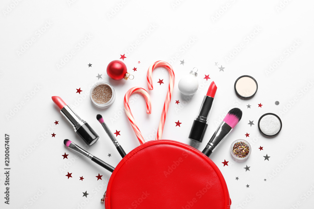 Flat lay composition with makeup products and Christmas decor on white background Flat lay composition with makeup products and Christmas decor on white background