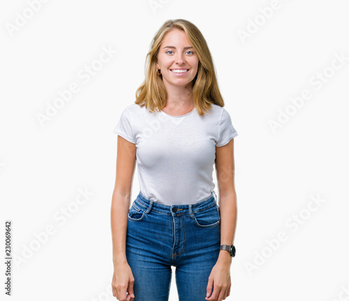Beautiful young woman wearing casual white t-shirt over isolated background with a happy and cool smile on face. Lucky person.