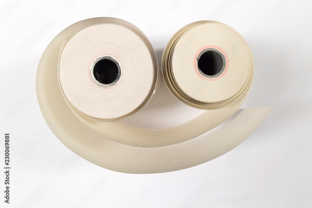 Old white paper rolls for printers on white background. Old white paper rolls for printers on white background.
