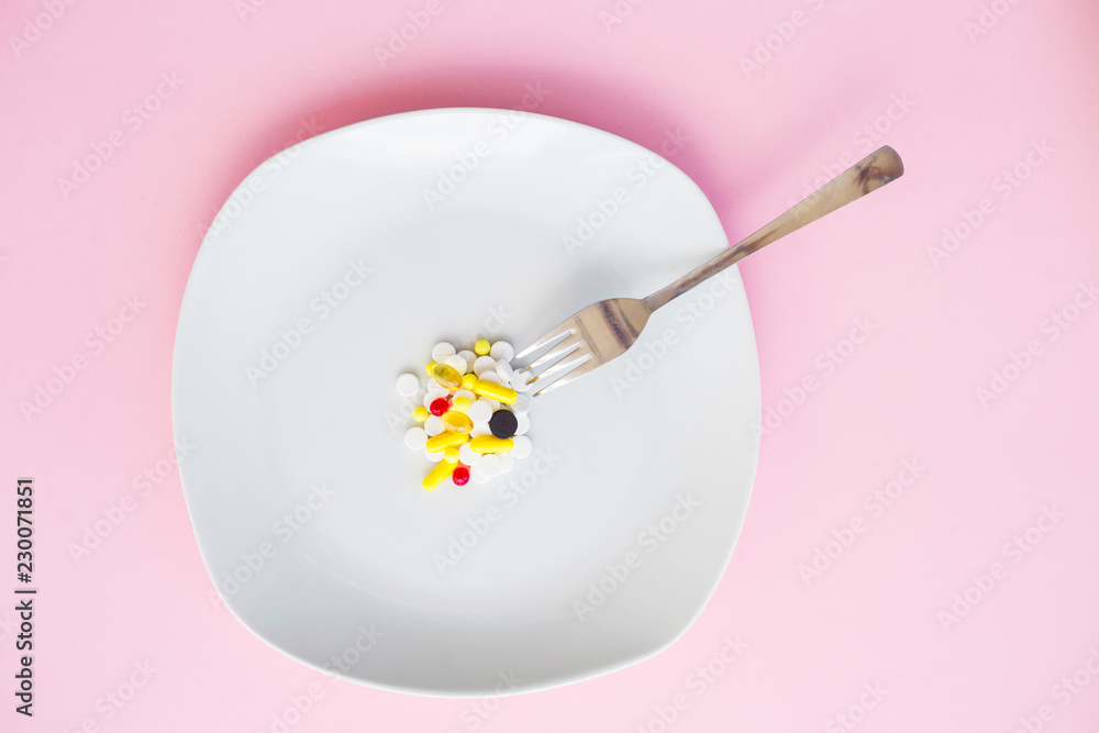 Close up of pills on plate. Dietary supplements. Variety pills. Vitamin capsules on plate Close up of pills on plate. Dietary supplements. Variety pills. Vitamin capsules on plate