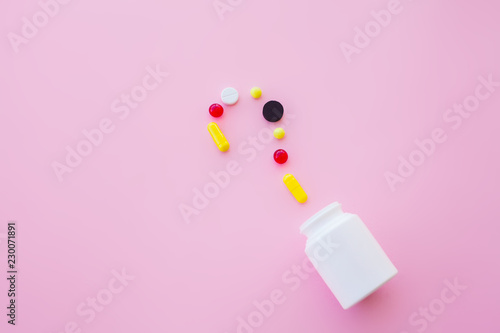 Close up of pills. Dietary supplements. Variety pills. Vitamin capsules on pink background