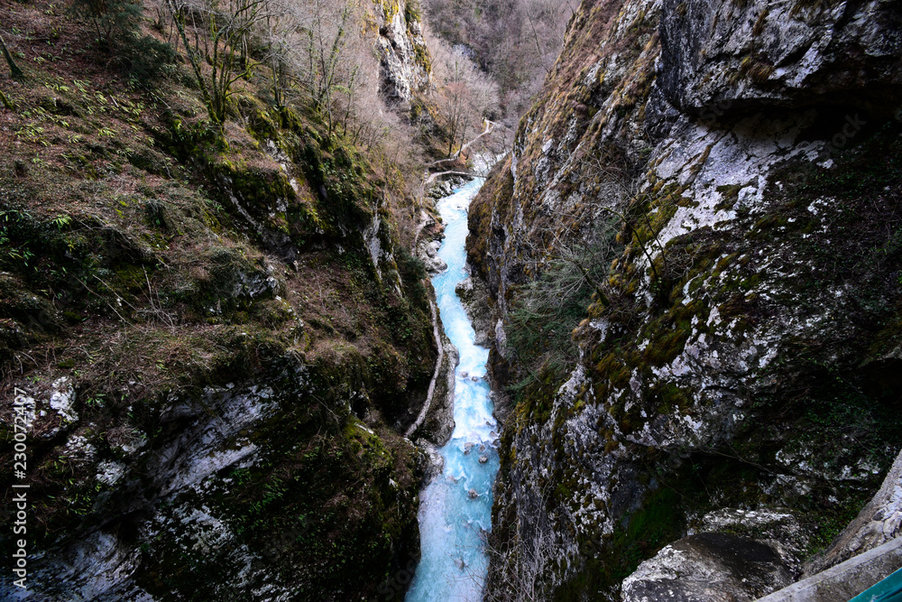 Obraz premium Tolmin Gorge (Tolminska Korita, Korita Tolminke) is a narrow canyon in Julian Alps, close to Tolmin, Soča Valley, Slovenia. Within the gorge is a clear stream with a number of rapid and waterfalls. 