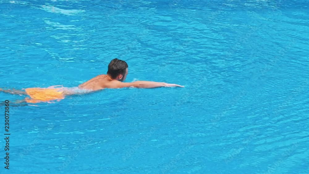 Happy young man at swimming pool. Happy young man at swimming pool.