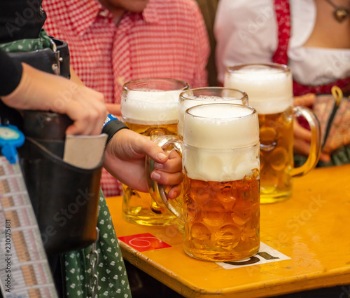 Oktoberfest, Munich, Germany. Waiter serving beers, closeup view