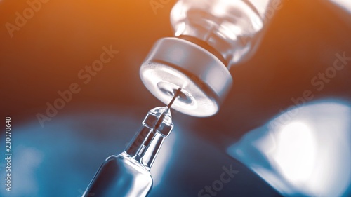 Vaccine vial dose flu shot drug needle syringe,medical concept vaccination hypodermic injection treatment disease care hospital prevention immunization illness disease  baby child.blue background 