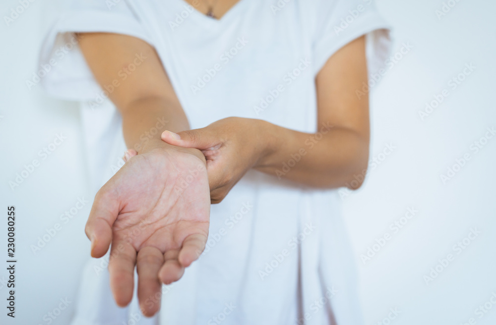 Woman hands checking her pulse with two fingers on wrist Woman hands checking her pulse with two fingers on wrist