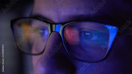 Man with Glasses Working in Office at Night
