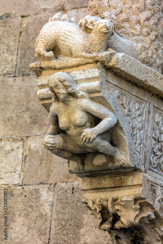 The portal of the Cathedral of Saint Mark in Korcula, Croatia, built by Bonino da Milano in 1412 contains typical Romanesque motifs such as a lion tearing its prey and a crouching figure of Eve