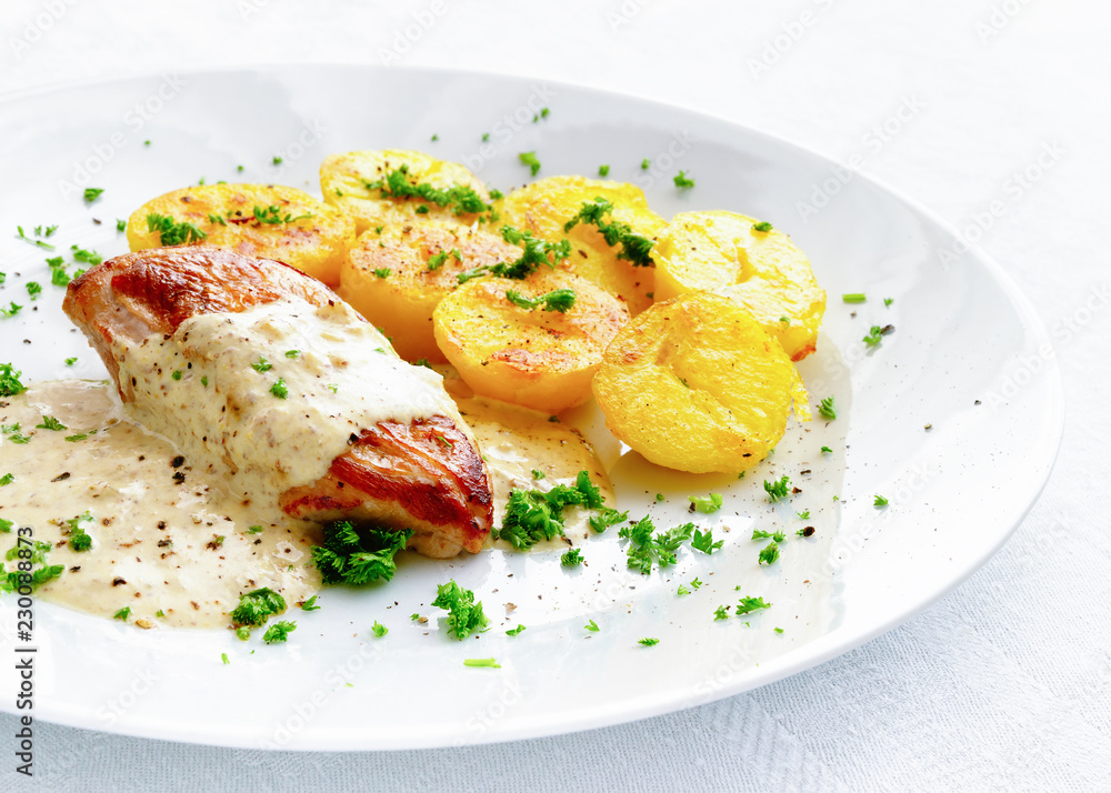 chicken filet under sour cream mustard sauce garnished with potato and sprinkled with parsley chicken filet under sour cream mustard sauce garnished with potato and sprinkled with parsley
