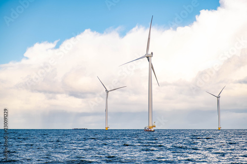 windmiil park in ocean, windmill farm rainy clouds photo