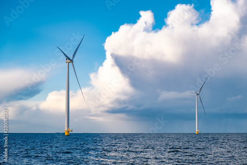 windmiil park in ocean, windmill farm rainy clouds photo