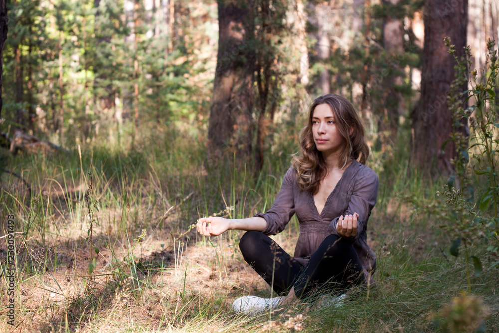 young woman meditates, practicing the smiling meditation young woman meditates, practicing the smiling meditation