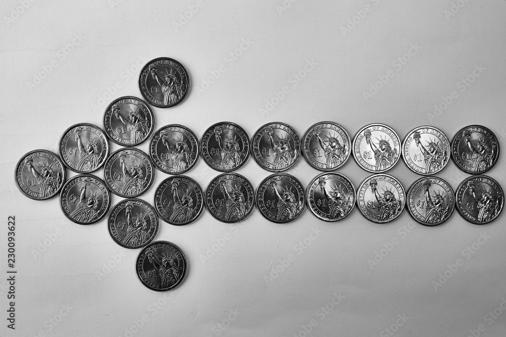 Design element. The arrow to the left is lined with coins of one US dollar. In the center - half a dollar. Design element. The arrow to the left is lined with coins of one US dollar. In the center - half a dollar.