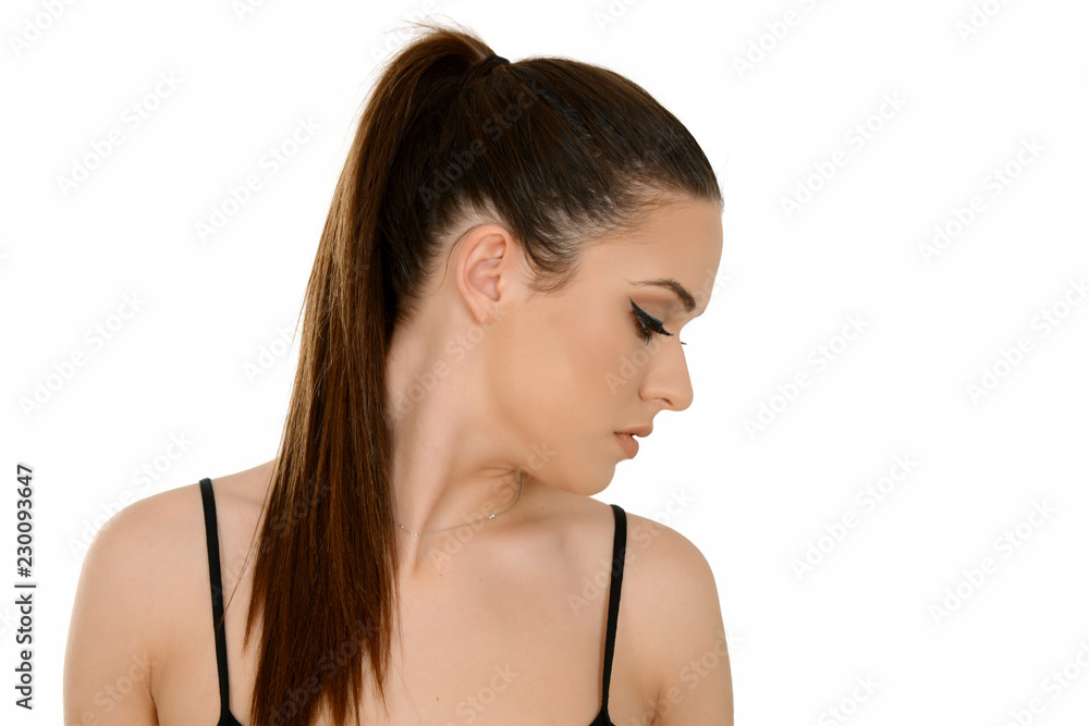 Young woman with healthy shining brown hairs put in pony tail. Young woman with healthy shining brown hairs put in pony tail.