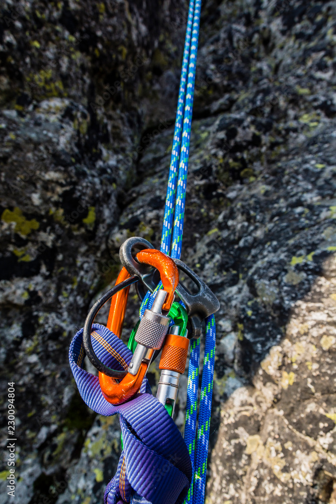 Rappel down on the climbing rope using a descender. Rappel down on the climbing rope using a descender.