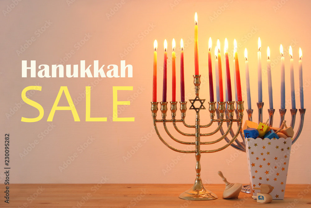 Image of jewish holiday Hanukkah background with traditional spinnig top, menorah (traditional candelabra) and burning candles. Image of jewish holiday Hanukkah background with traditional spinnig top, menorah (traditional candelabra) and burning candles.