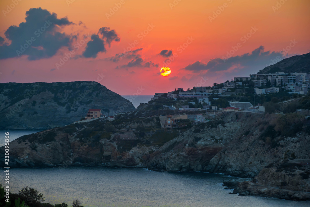 Sunrise in Agia Pelagia village on Crete island, Greece. Red sunrise colors and nice blue sky's