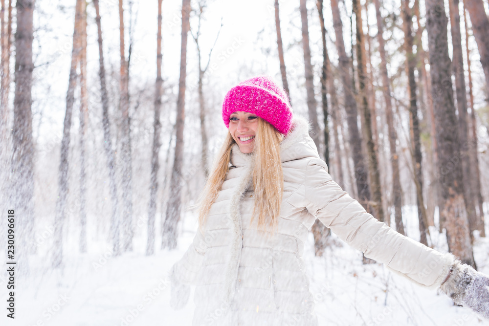 Happy young woman plays with a snow at snowy forest outdoor Happy young woman plays with a snow at snowy forest outdoor
