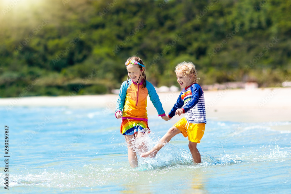 Kids on tropical beach. Children playing at sea. Kids on tropical beach. Children playing at sea.