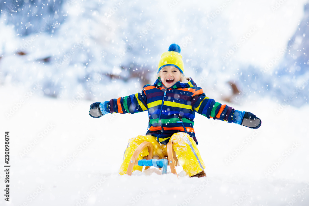 Boy on sled ride. Child sledding. Kid on sledge Boy on sled ride. Child sledding. Kid on sledge