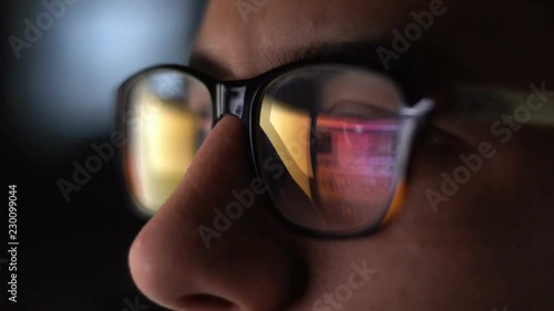 Man with Glasses Working in Office at Night