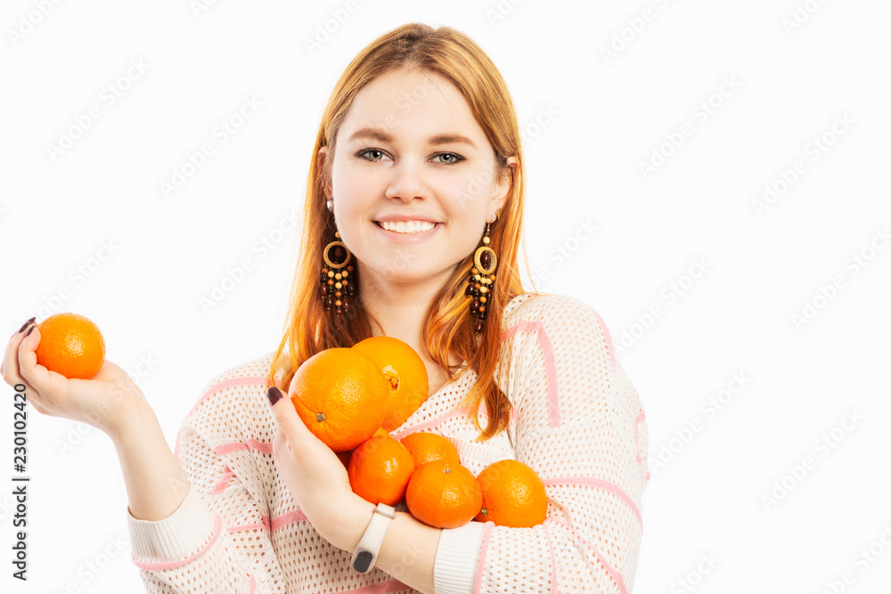 Young smiling woman with an armful of oranges, isolated on white background Young smiling woman with an armful of oranges, isolated on white background