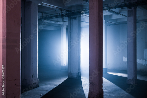 Illuminated poles in the basement of an industrial warehouse