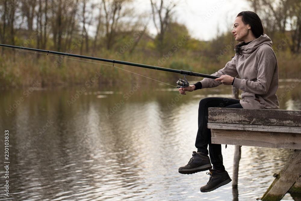 woman fisher sitting on summer sea beach