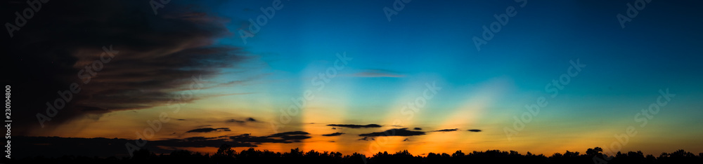 Heavy sun rays on horizon after sunset in Florida panorama