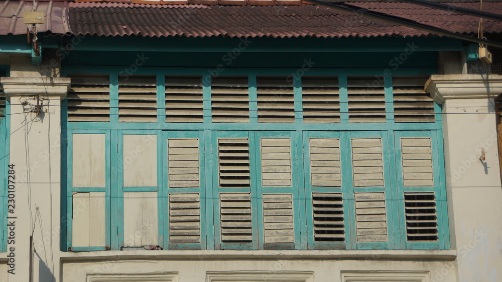 Beautiful blue windows of old shophouse in George Town, Penang