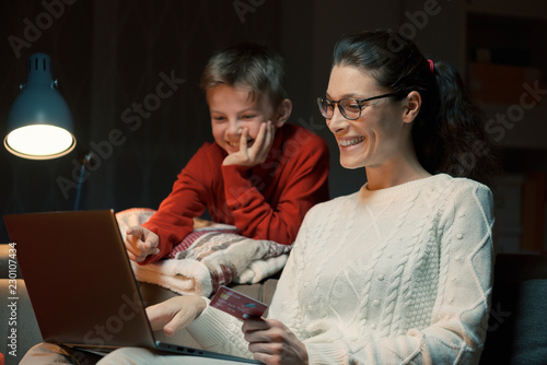 Mother and son doing online shopping together