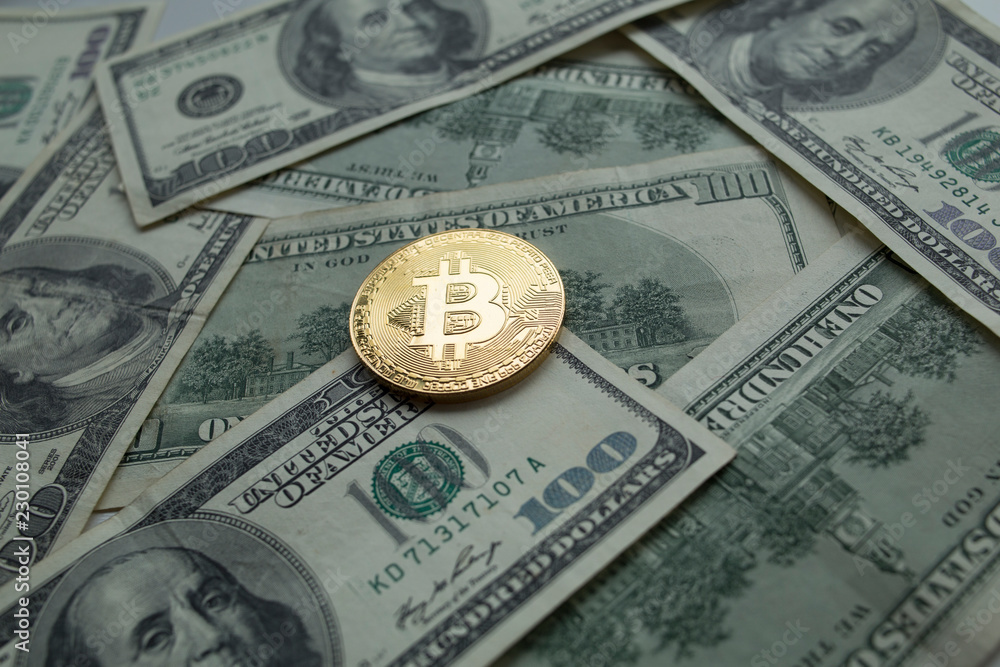 Golden Bitcoins Coins lying on dollars. Golden Bitcoins Coins lying on dollars.