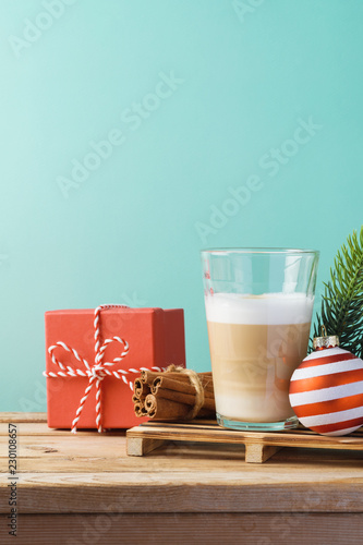 Hot Latte macchiato coffee cop  on wooden table. Christmas menu concept photo